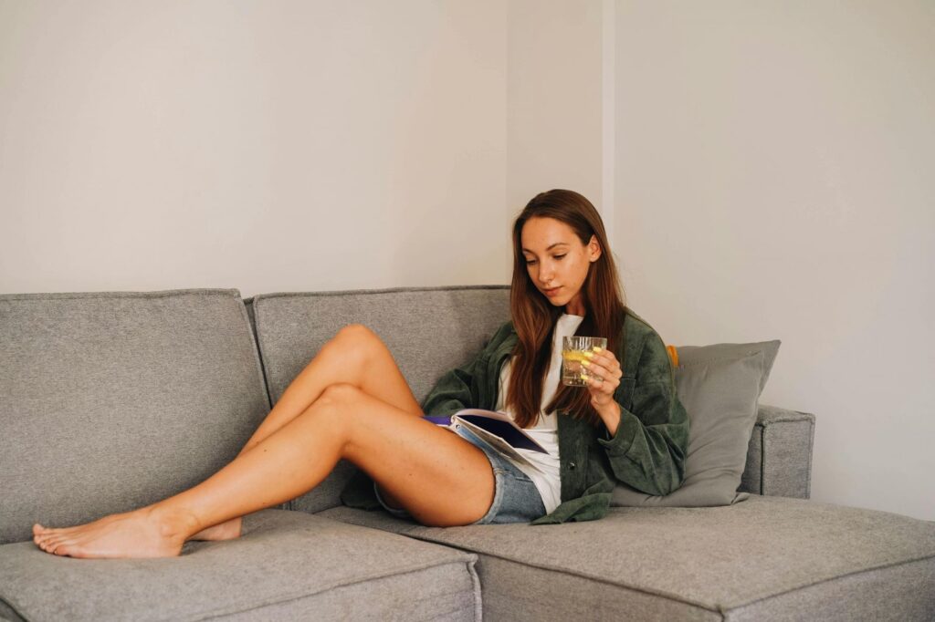 woman on couch home decor trends 2025 farmohuse at lantern commons blog luxury apartments in westfield
