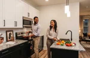 Couple preparing a meal together in a modern apartment kitchen
