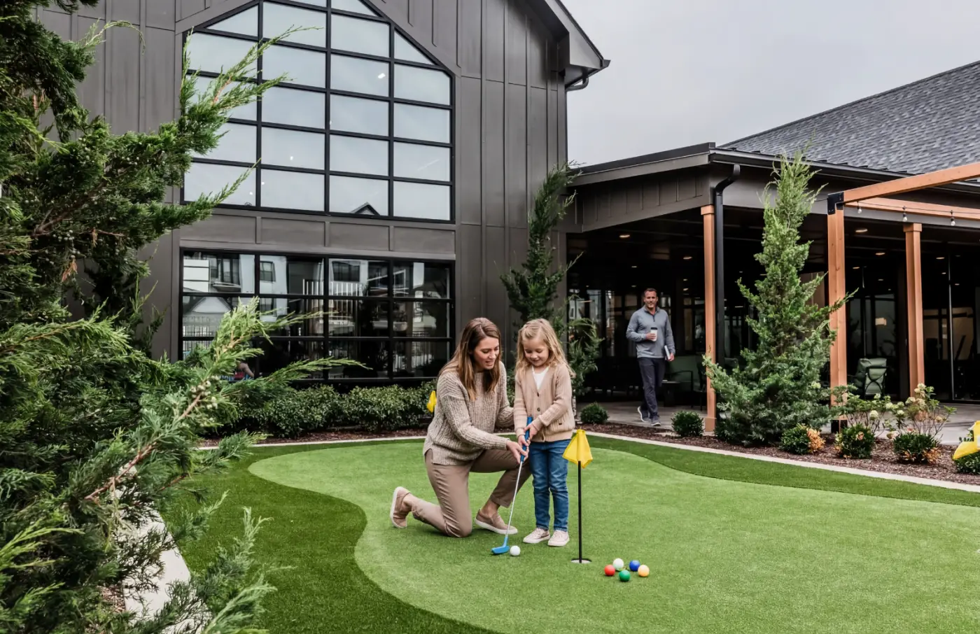 11 Parent and child play on community putting green outside the clubhouse