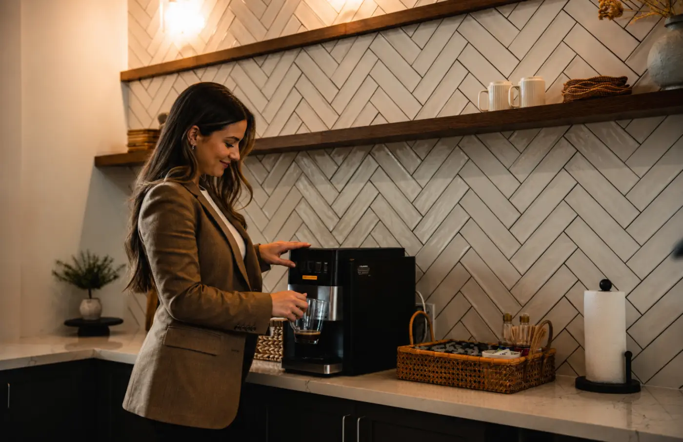 Resident using the complimentary coffee station in the clubhouse