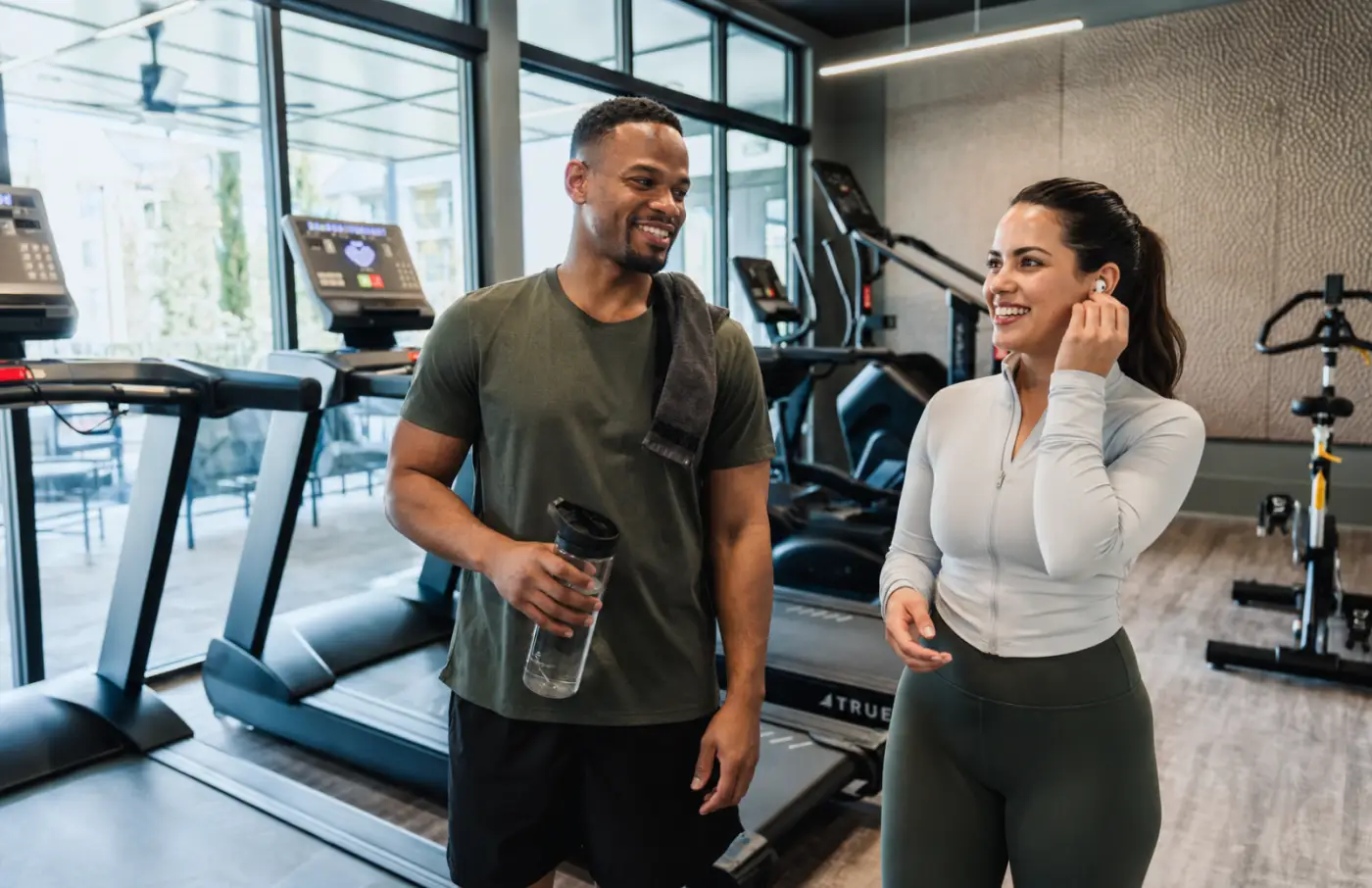 Residents chat after a workout in the apartment fitness center